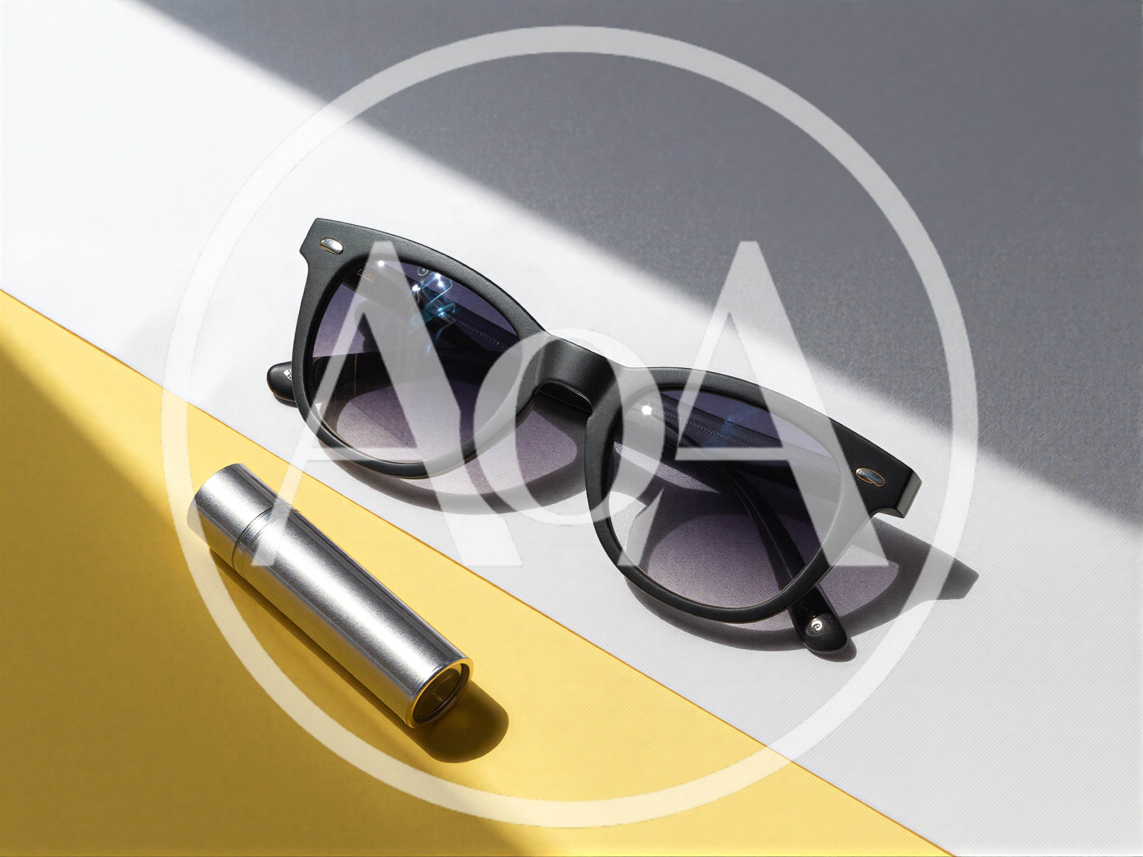 Sunglasses And Metal Lipstick Tube On Geometric Background