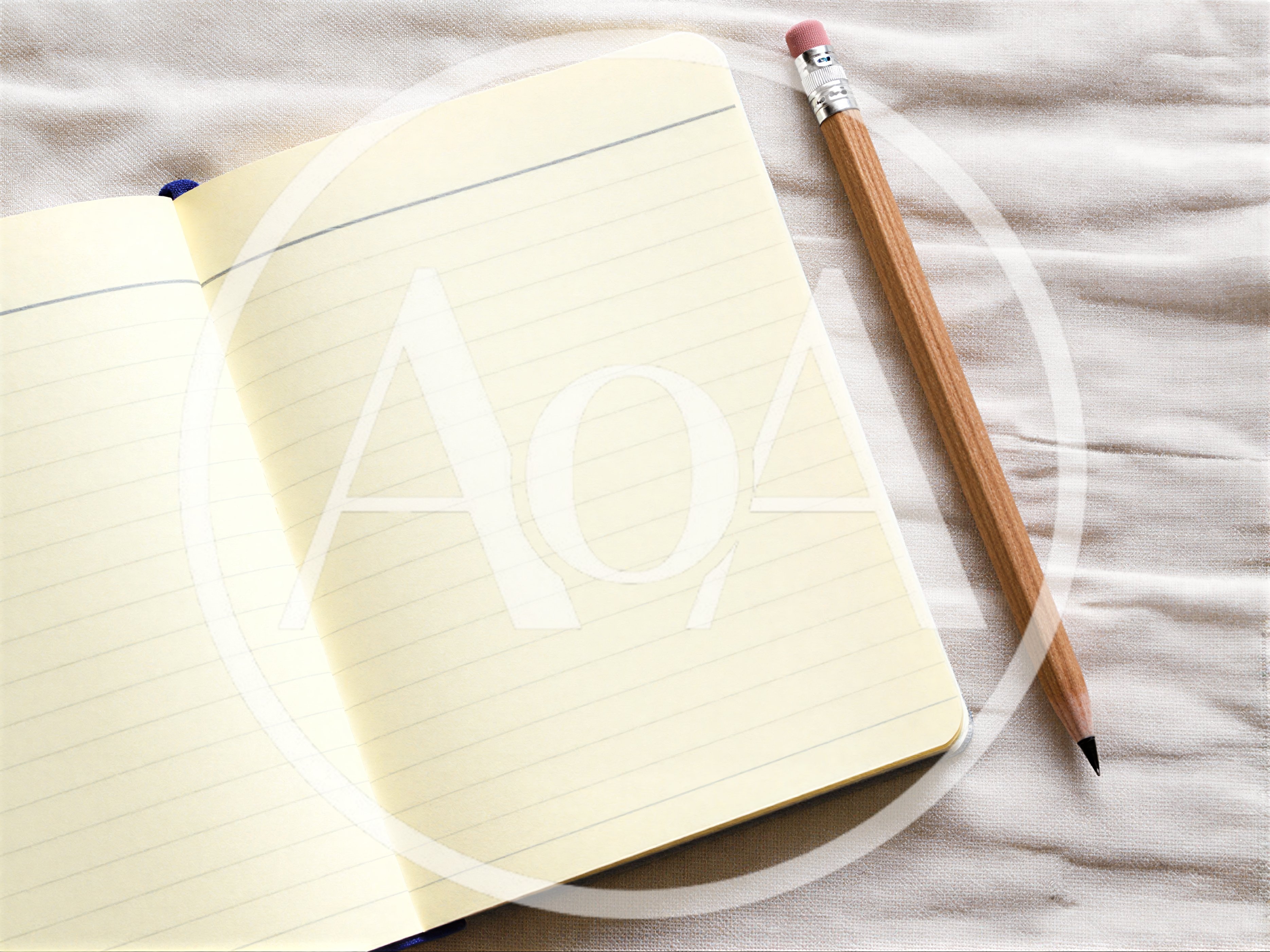 Open Notebook With Pencil On Textured Fabric