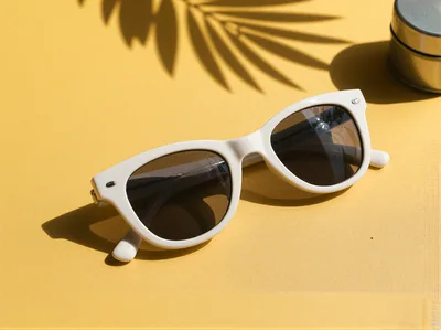 White Sunglasses On A Yellow Background