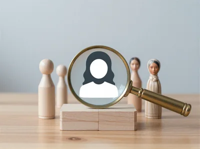 Magnifying Glass Focusing On Female Icon Among Wooden Figurines