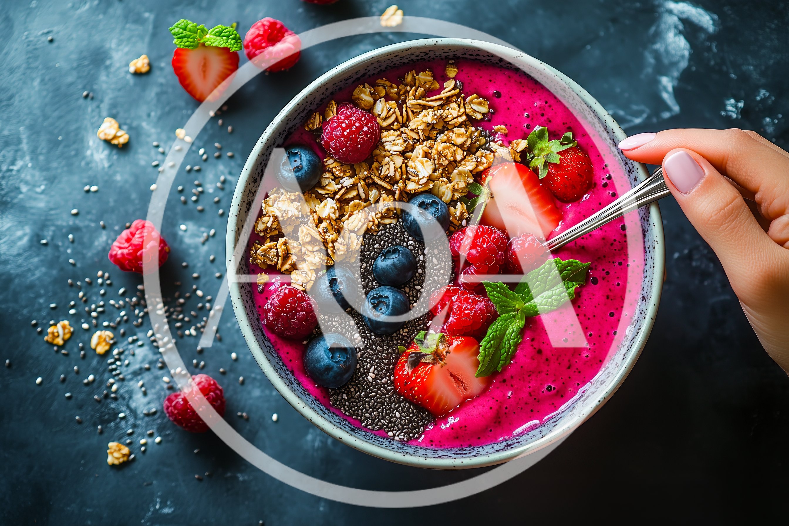 Hand Holding Spoon Over Vibrant Dragon Fruit Smoothie Bowl