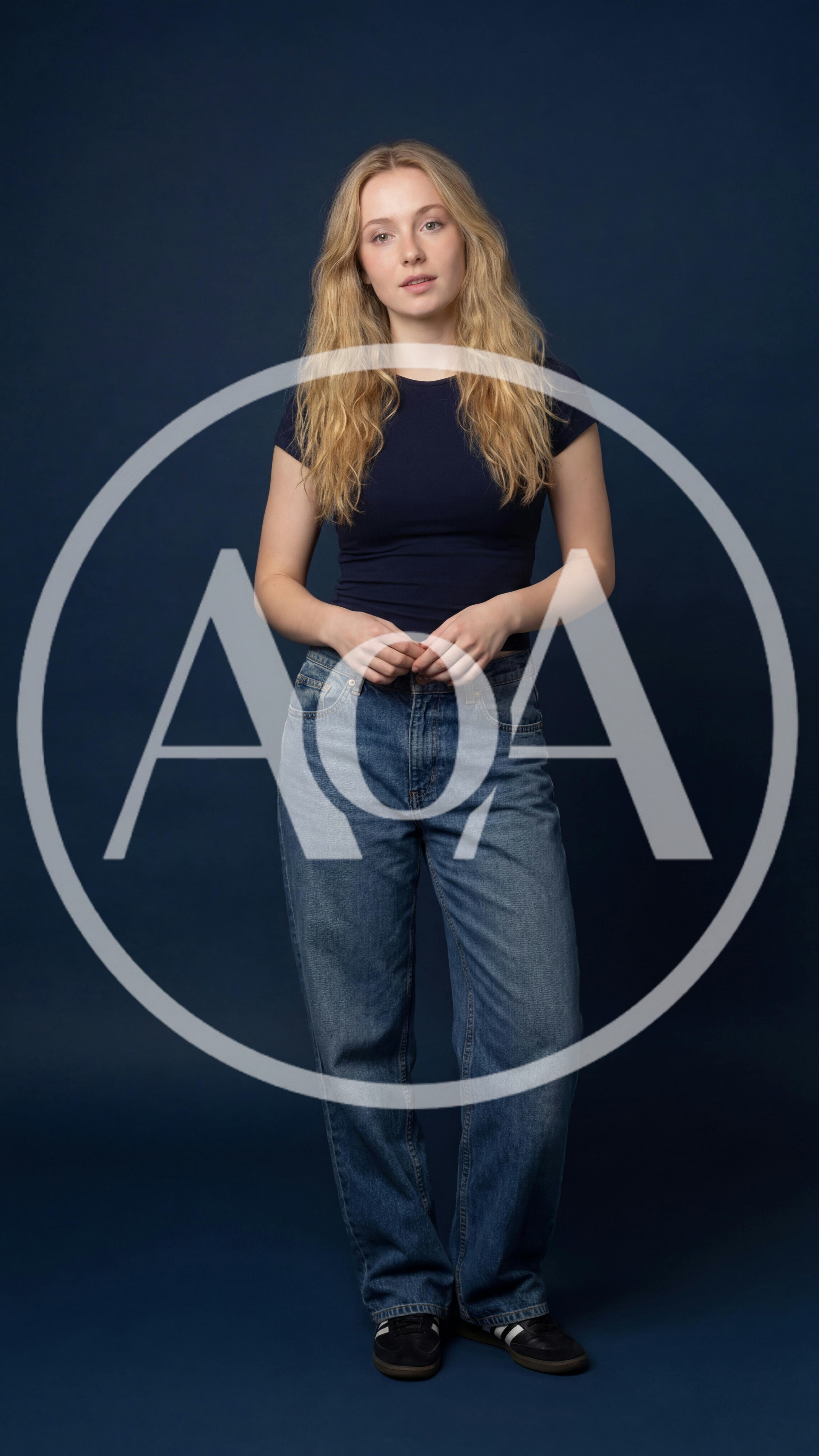Young Woman Standing Against A Solid Blue Background