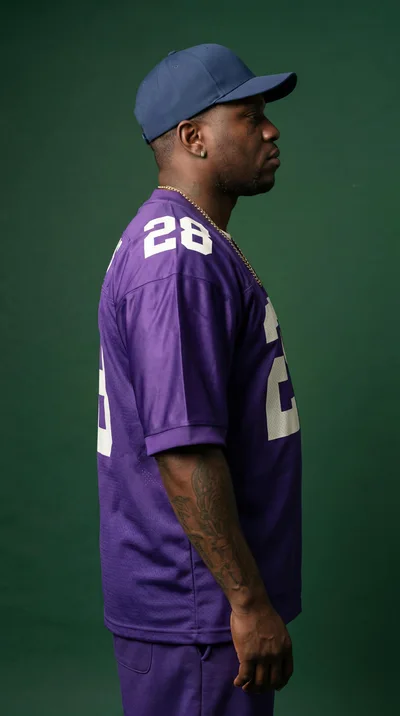 Side Profile Of A Man Wearing A Purple Jersey