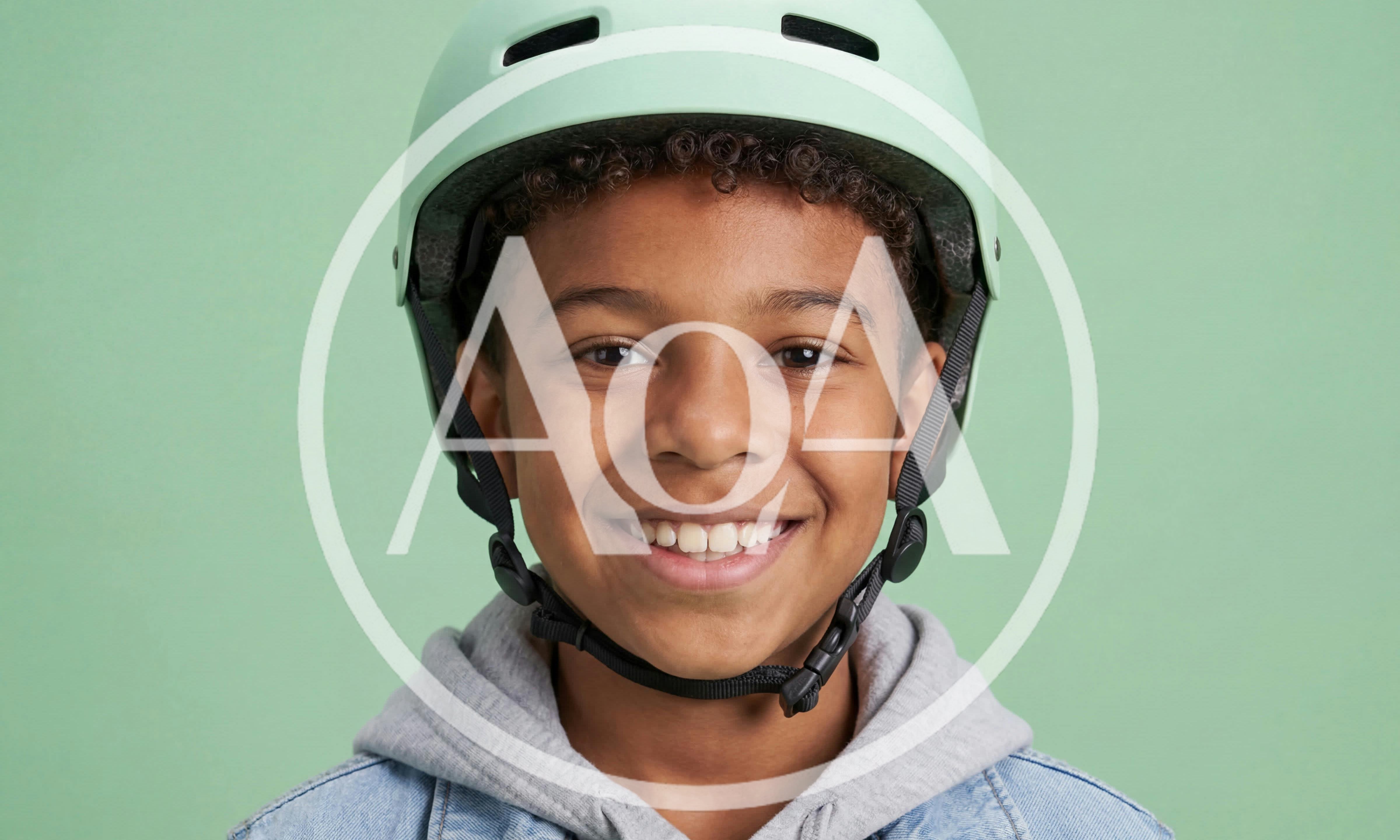 Smiling Young Boy Wearing A Protective Helmet