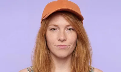 Portrait Of A Young Woman Wearing An Orange Cap