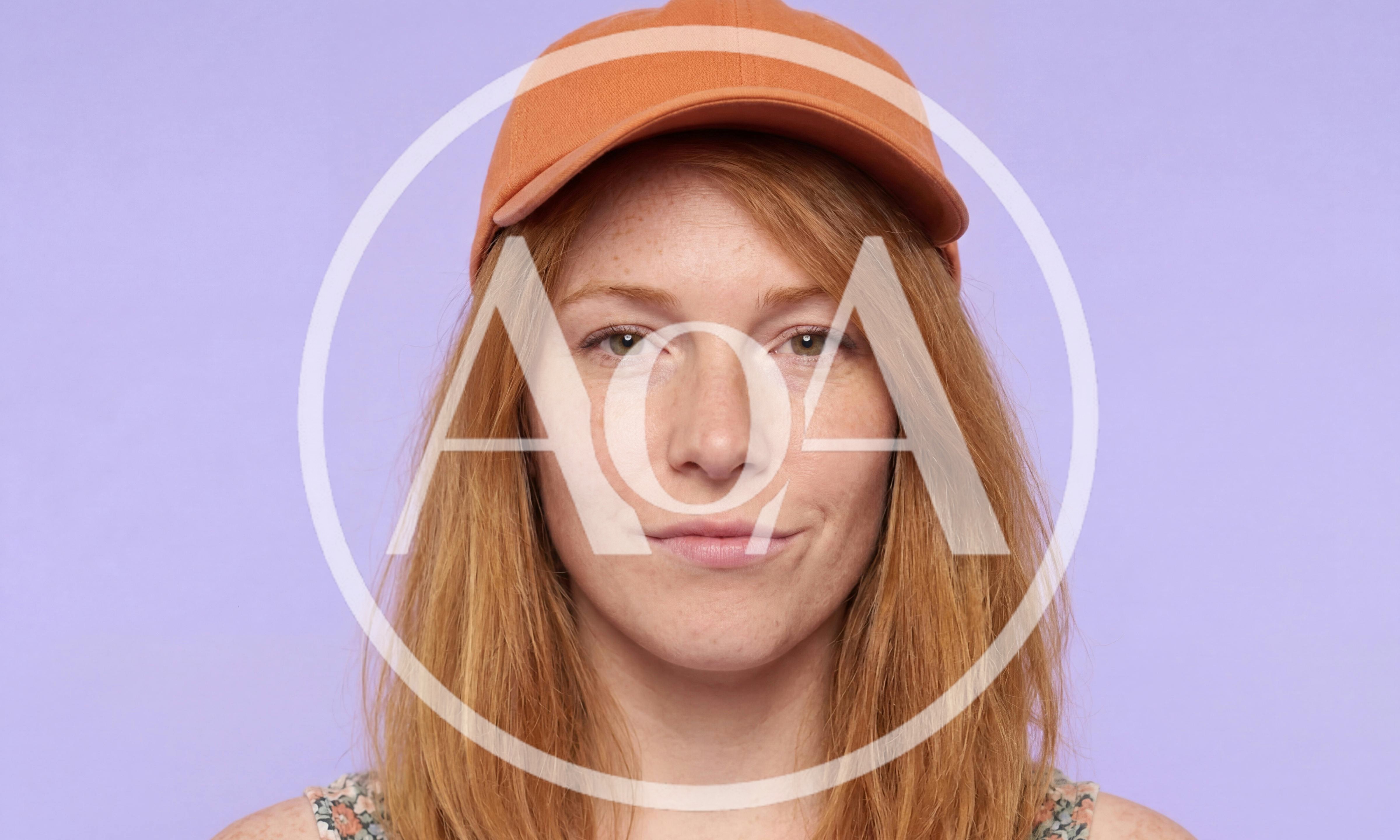 Portrait Of A Young Woman Wearing An Orange Cap
