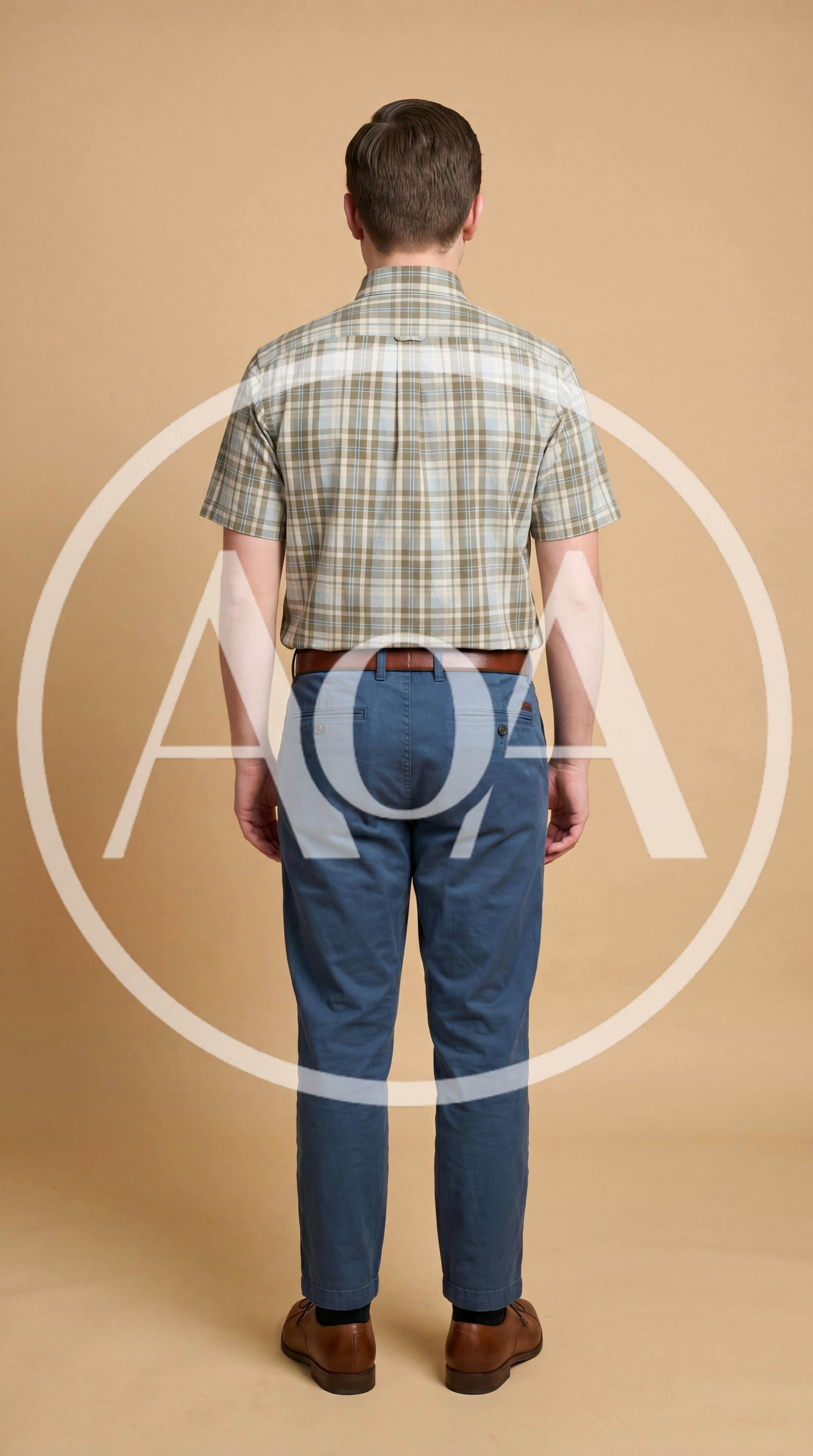 Man Standing In Plaid Shirt And Blue Chinos