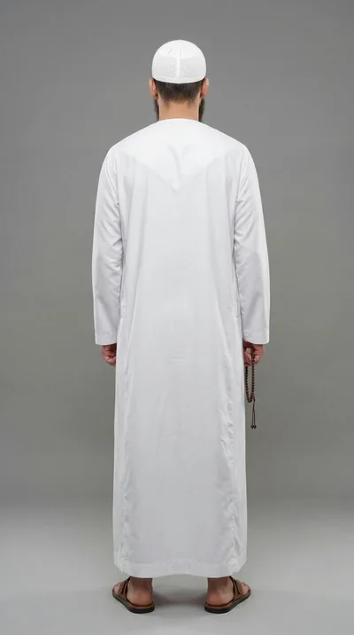 Man In Traditional Thobe And Kufi Standing Back View