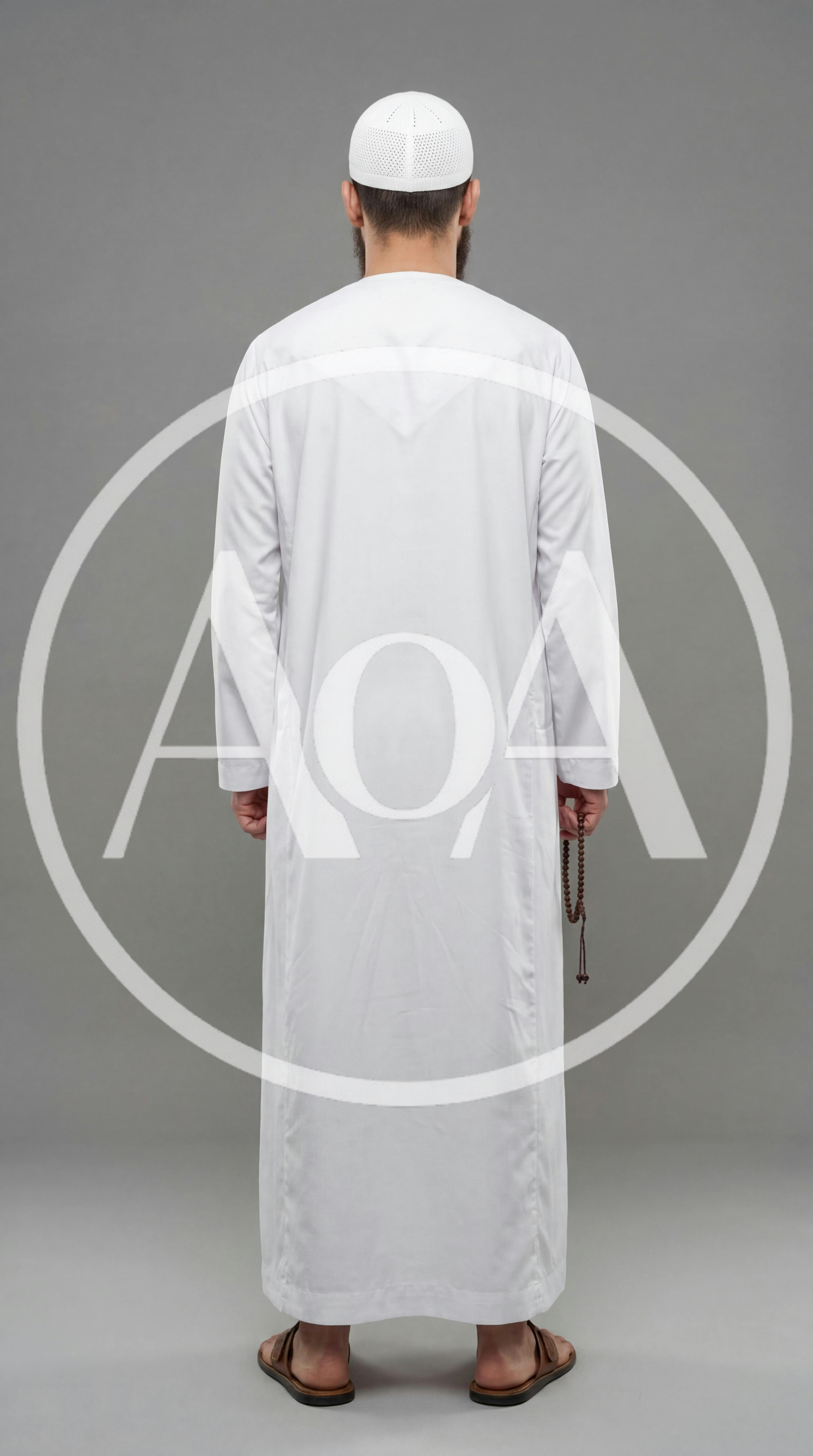 Man In Traditional Thobe And Kufi Standing Back View
