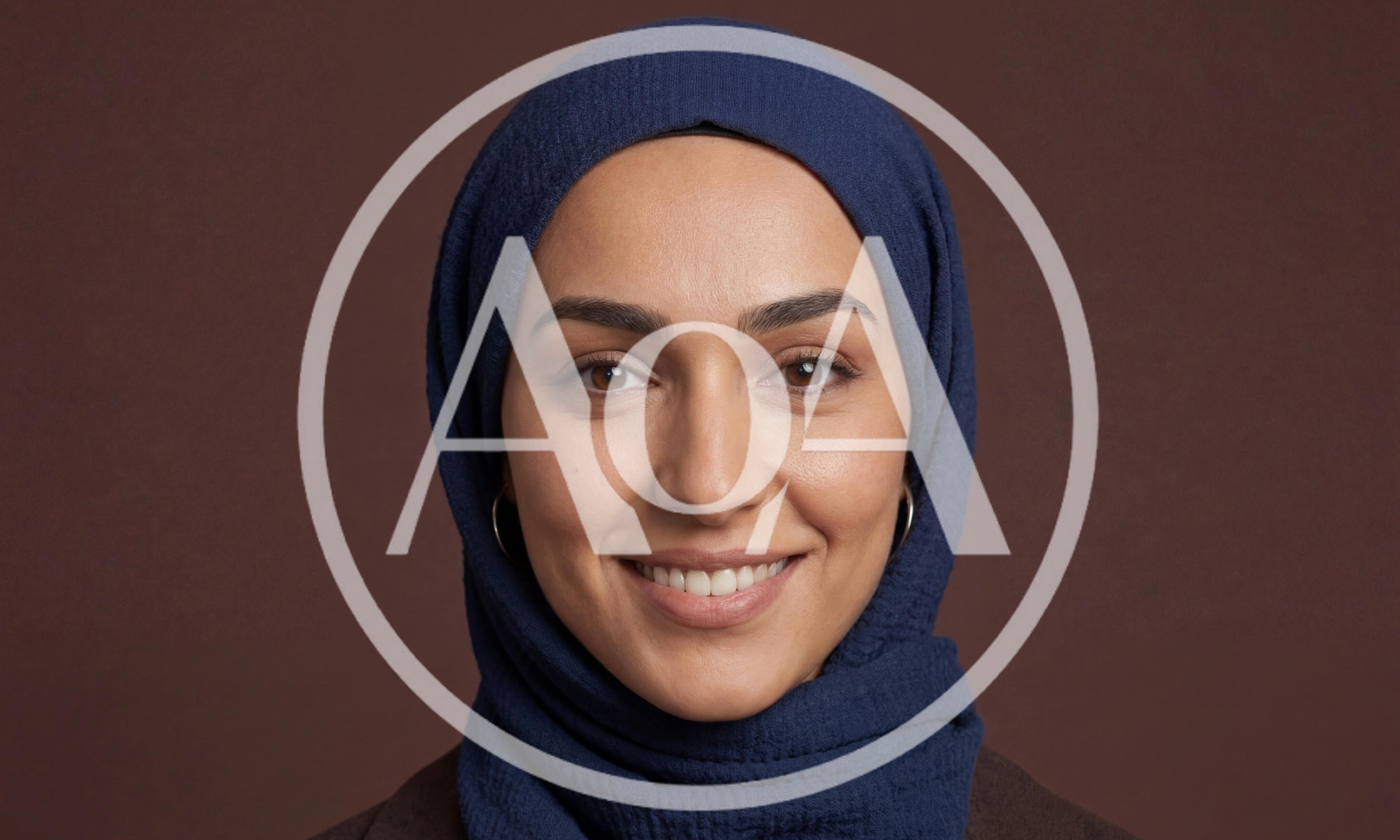 Portrait Of A Smiling Woman Wearing A Blue Hijab