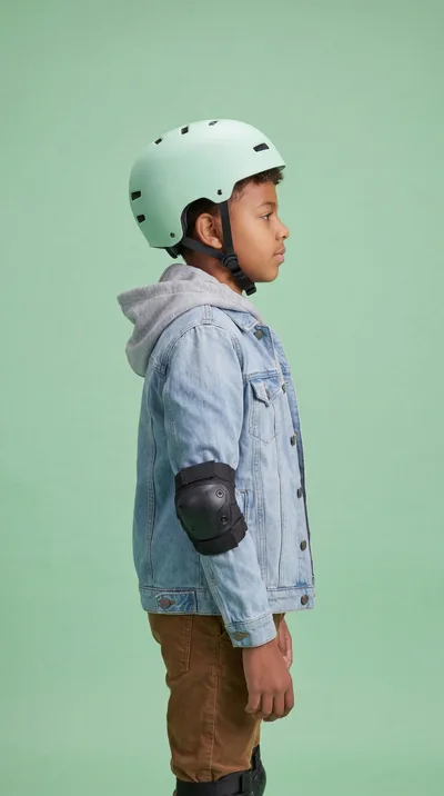 Young Boy Wearing Protective Gear For Skating
