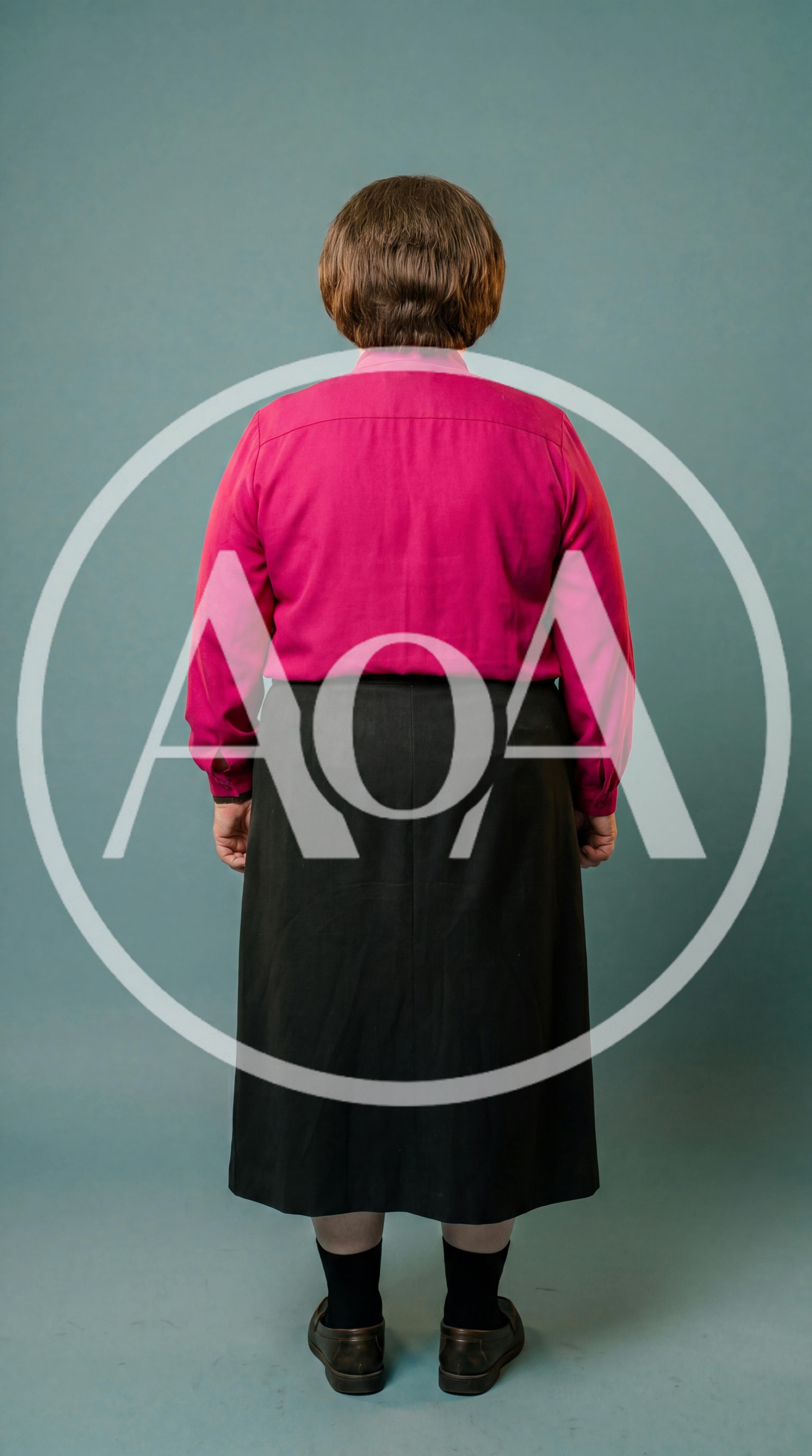 Back View Of A Woman Standing In A Pink Shirt