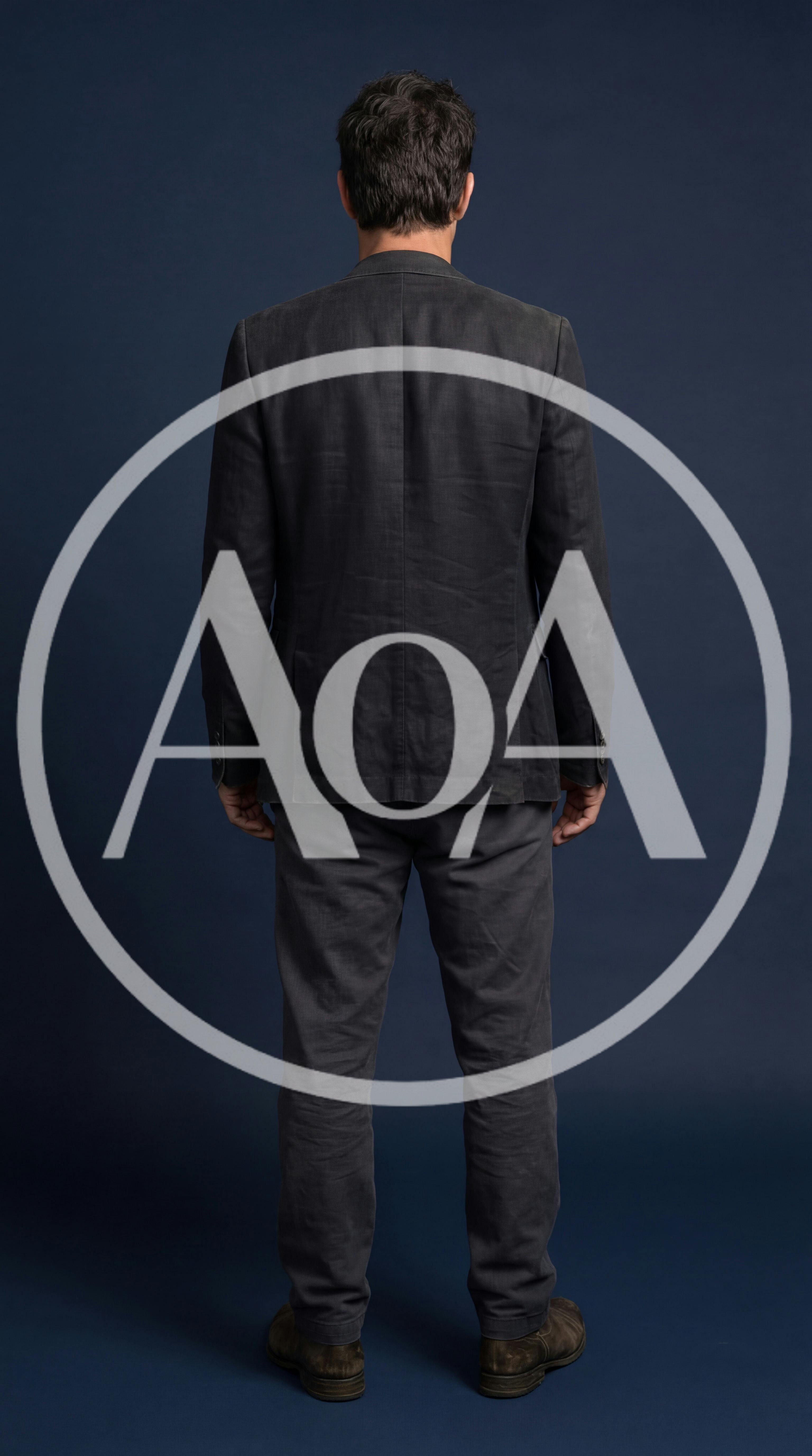 Man Standing In A Dark Grey Suit Back View