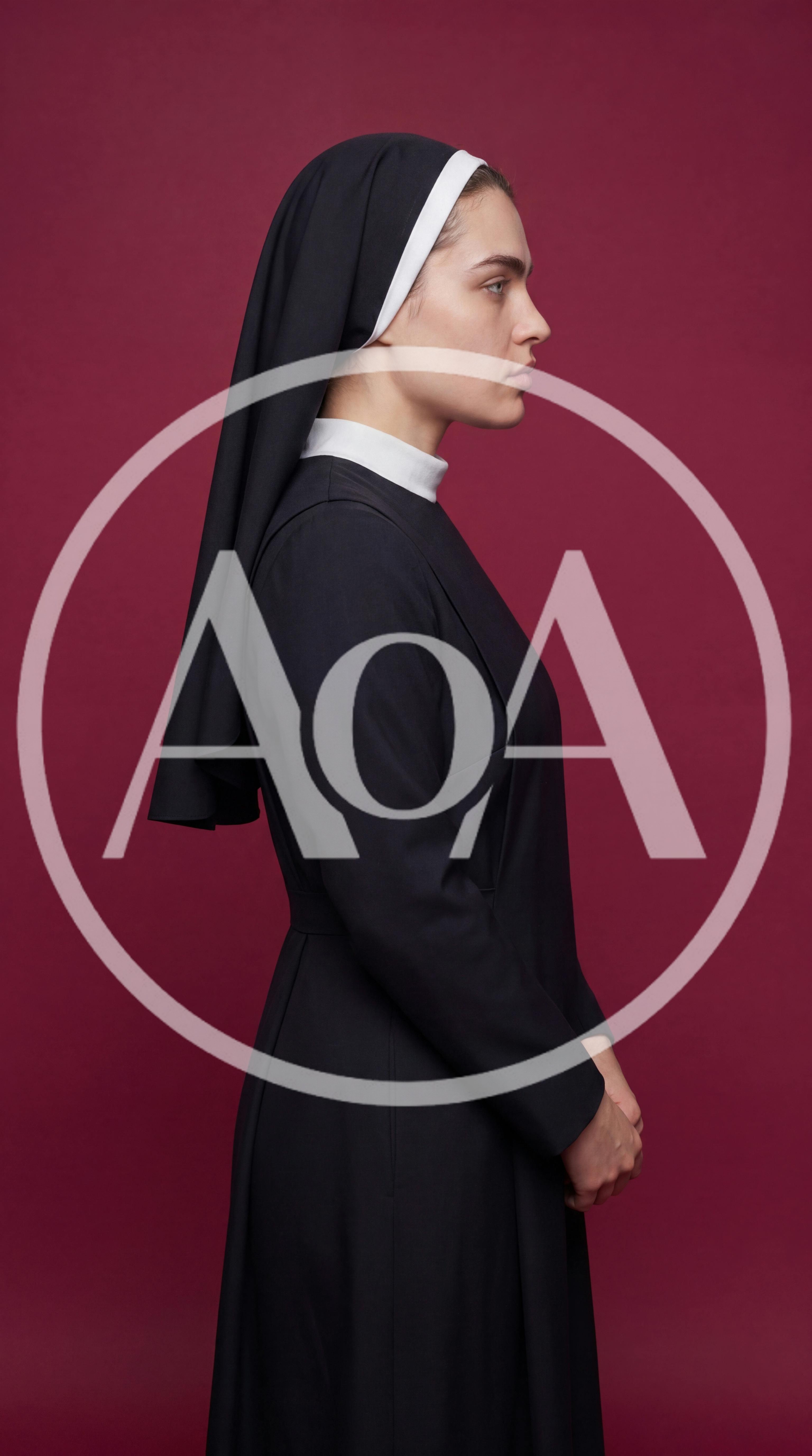 Young Nun Standing In Profile Against Maroon Background