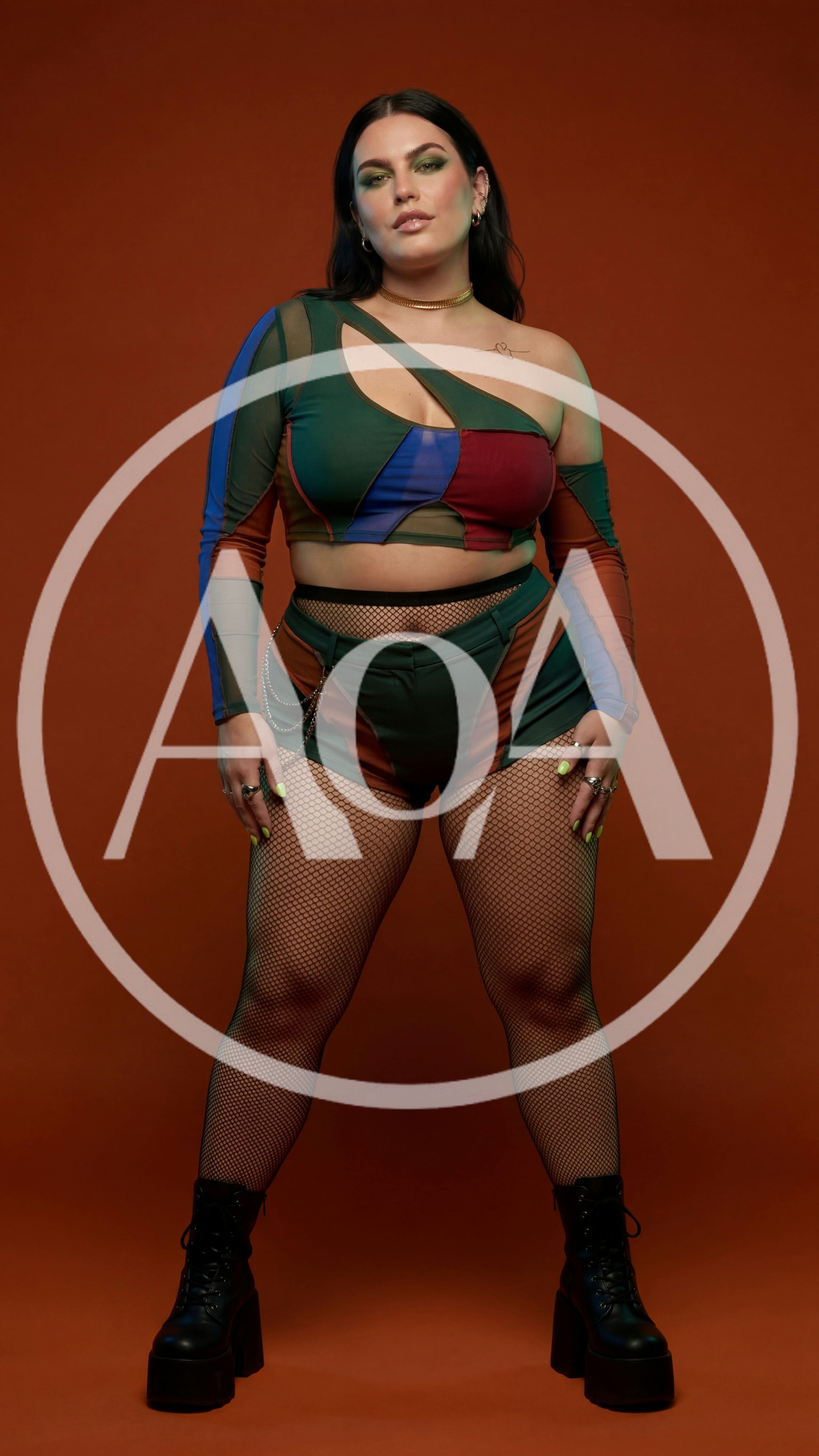 Plus Size Fashion Model Posing In Colorful Patchwork Outfit