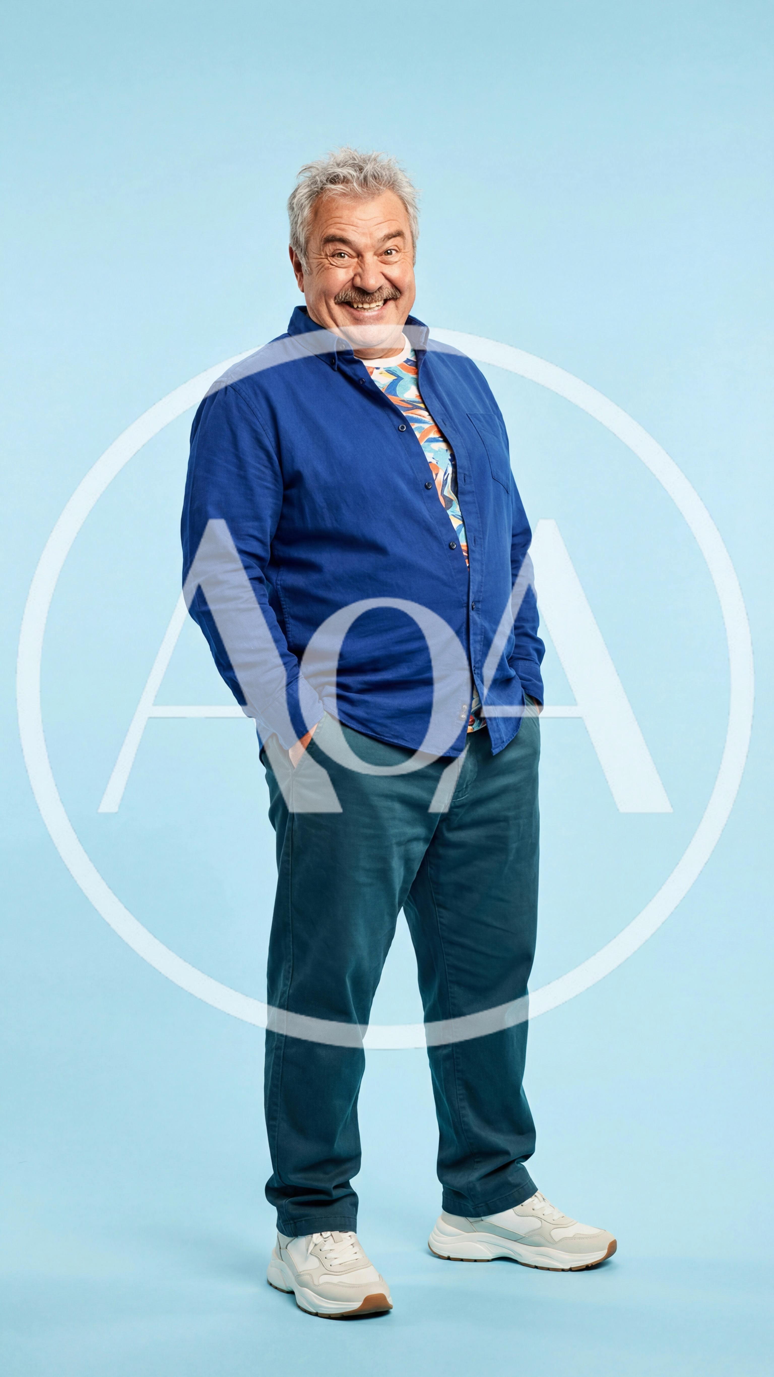 Smiling Mature Man Standing Against Blue Background