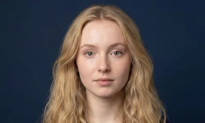 Portrait Of A Young Blonde Woman Looking At Camera