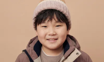 Portrait Of A Smiling Young Asian Boy