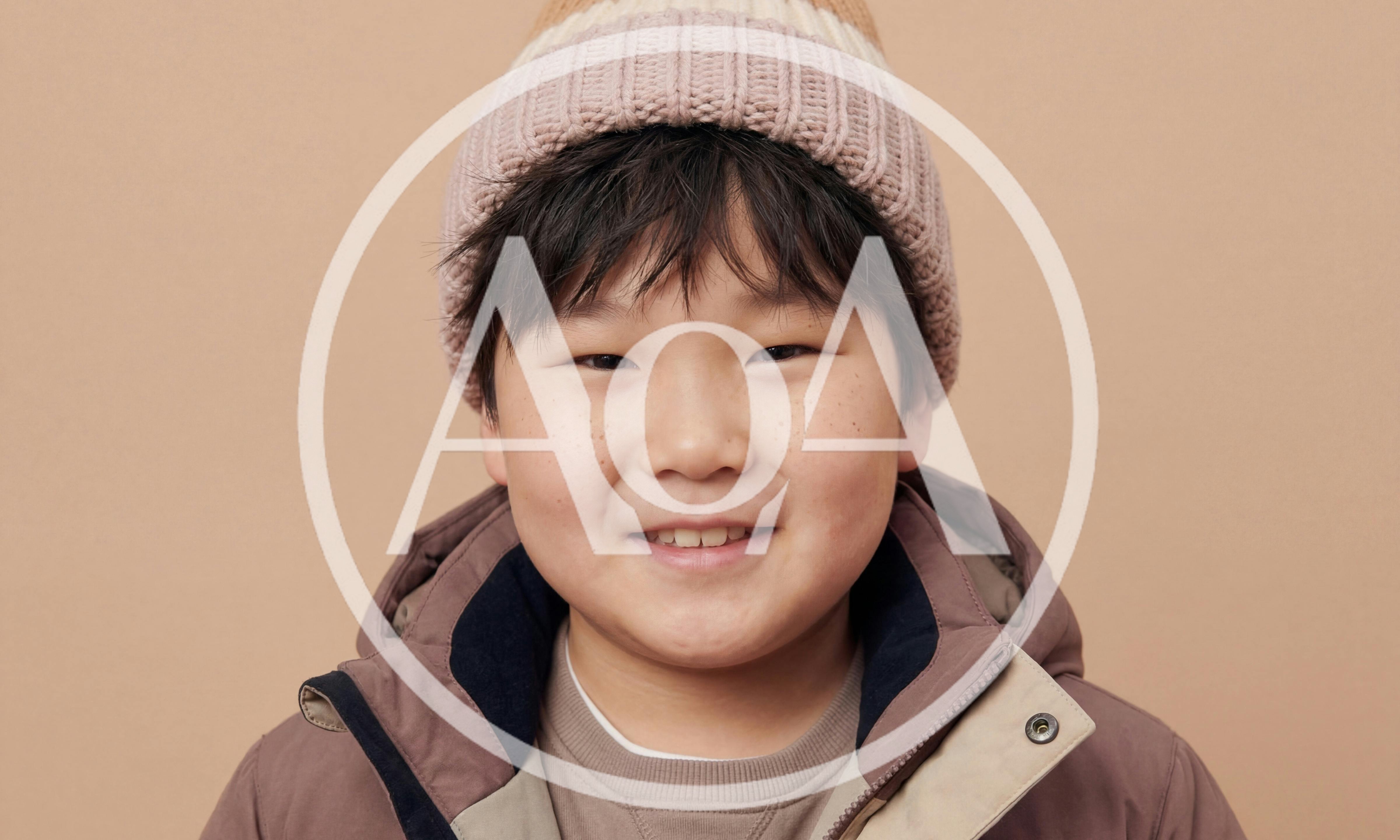 Portrait Of A Smiling Young Asian Boy