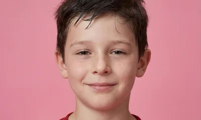Portrait Of A Young Boy Smiling At Camera