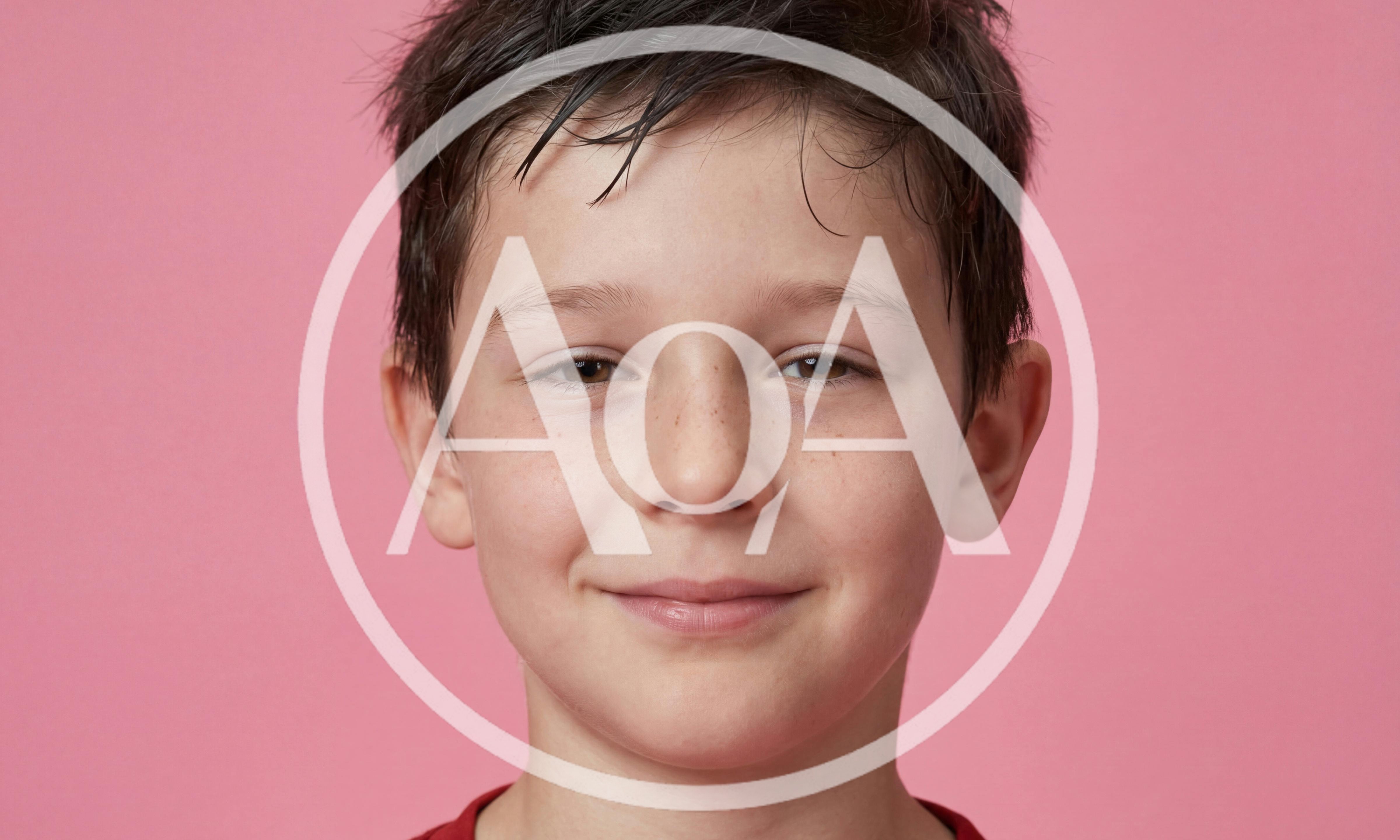 Portrait Of A Young Boy Smiling At Camera