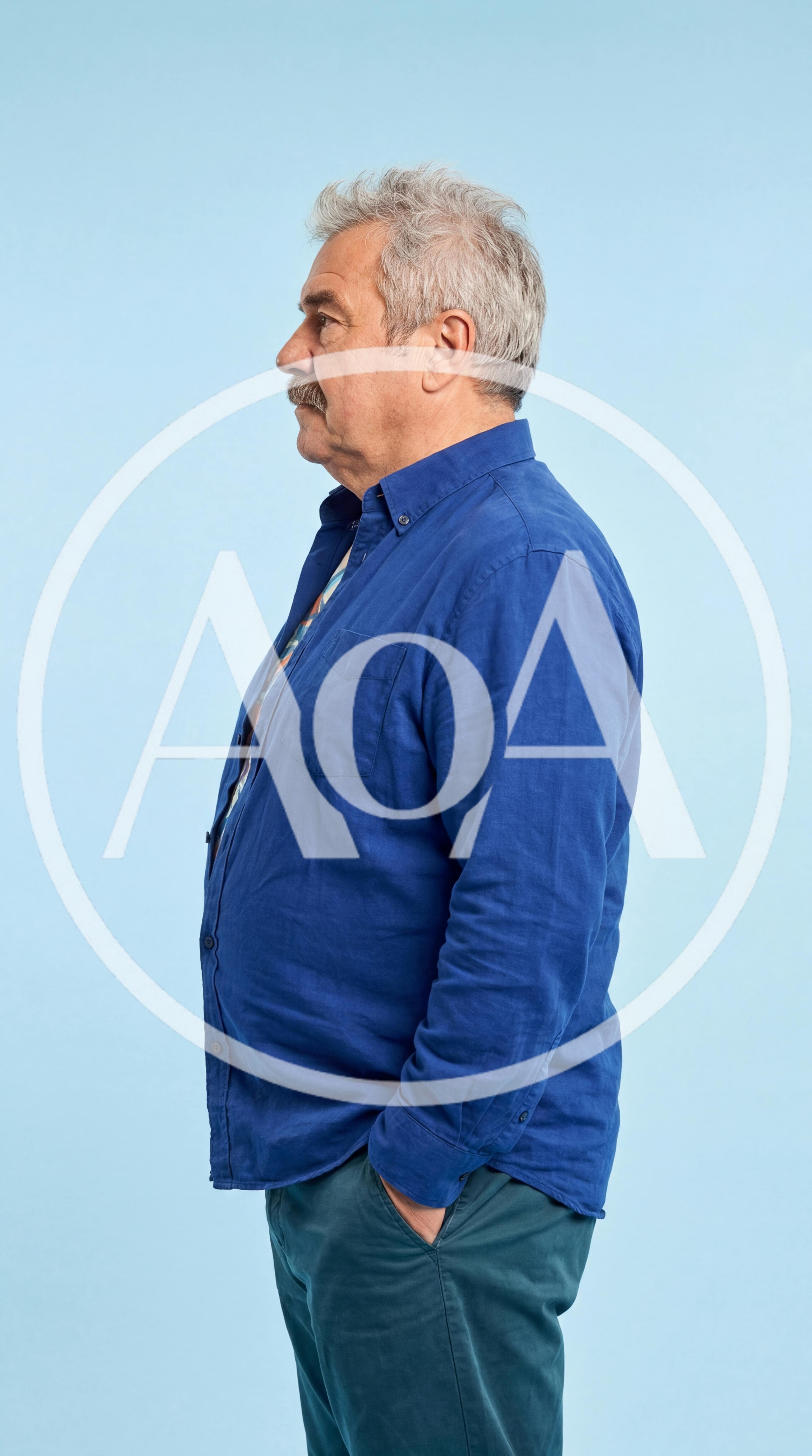 Side Profile Of A Senior Man In A Blue Shirt