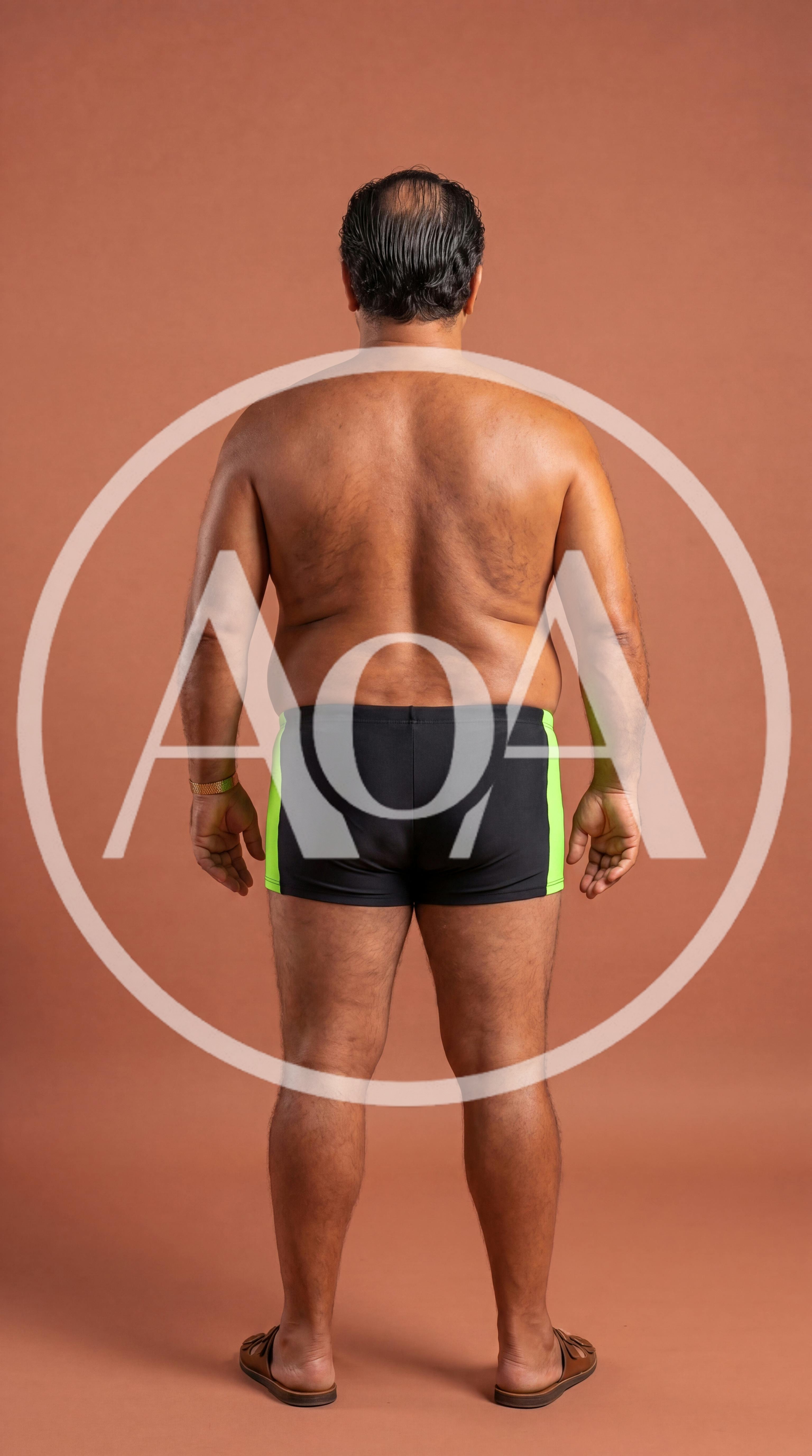 Back View of Middle Aged Man in Swim Trunks