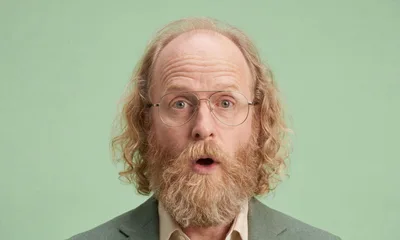 Surprised Middle Aged Man With Beard And Glasses