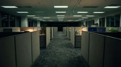 Empty Office Cubicles In A Dimly Lit Corporate Workspace