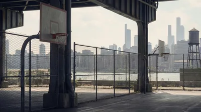Urban Basketball Court Under Bridge With City Skyline