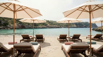 Luxury Beach Lounge Chairs With Umbrellas On Tropical Shore