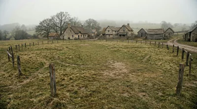 Medieval Village Settlement In A Misty Rural Landscape