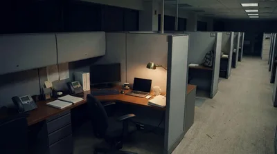 Empty Office Cubicles In A Dimly Lit Workplace
