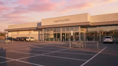 Exterior View Of A Modern Supermarket At Sunset