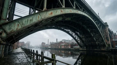 Industrial Steel Arch Bridge Over River In Manchester