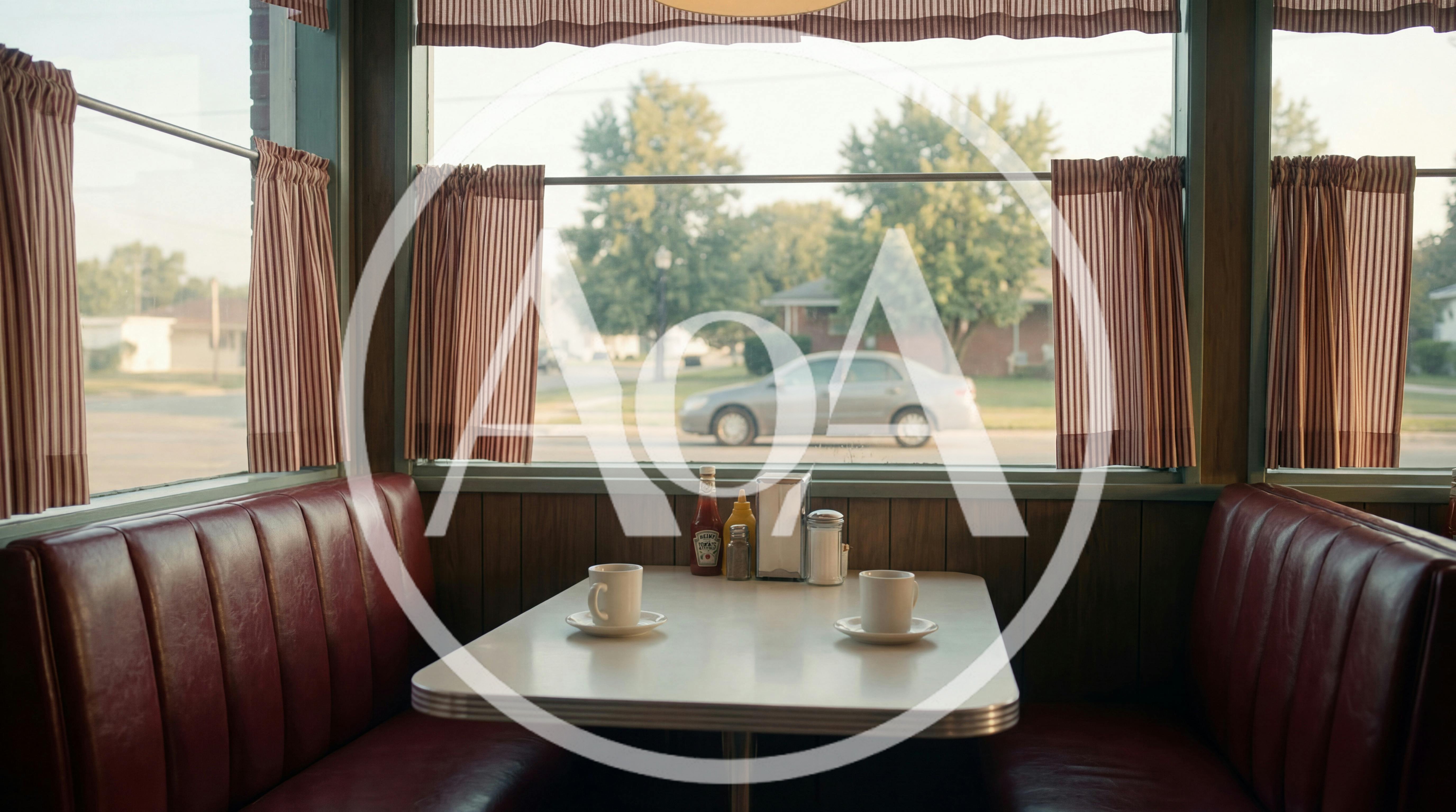 Empty Diner Booth With Coffee Cups And Condiments