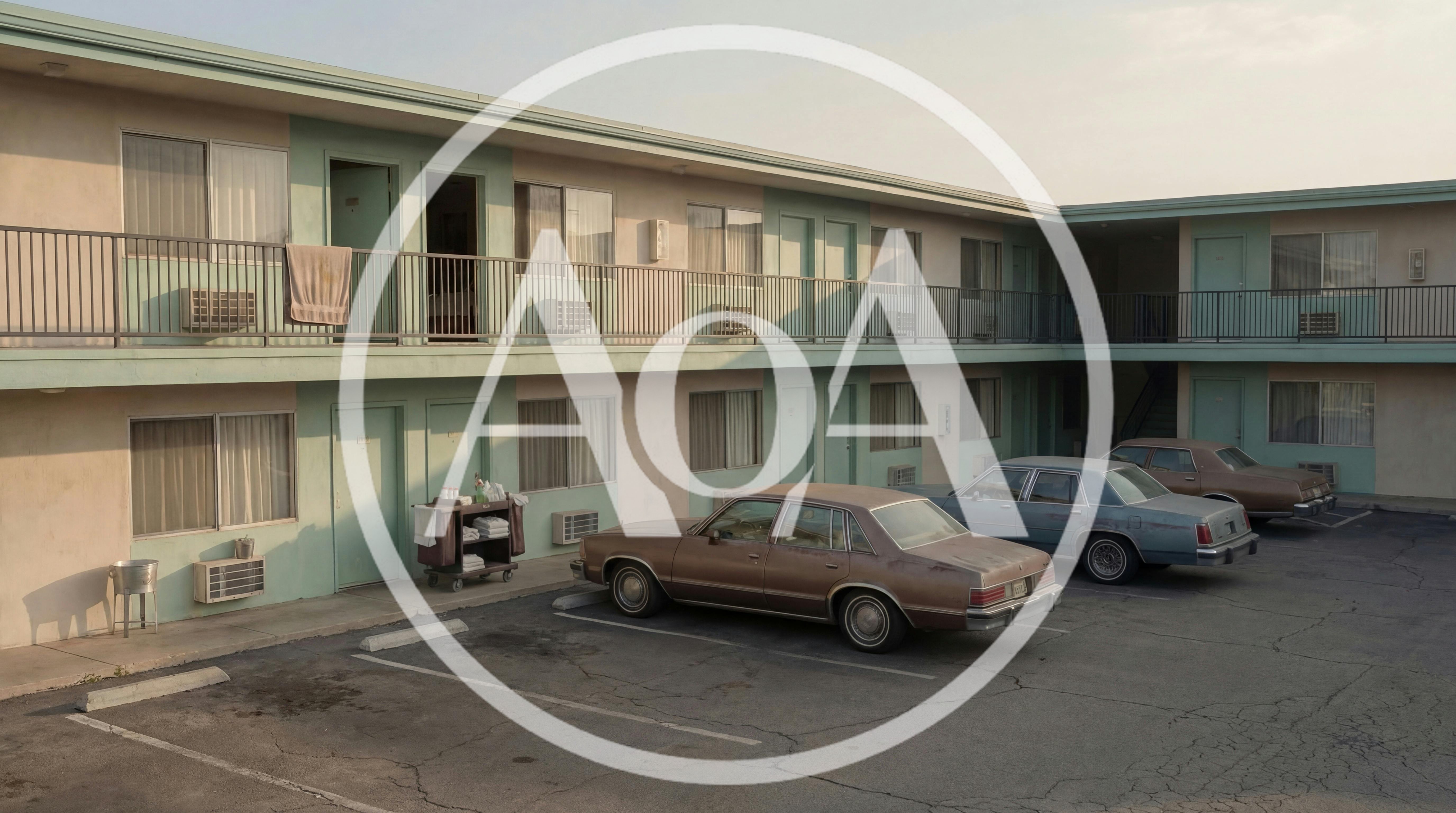 Vintage Motel Exterior With Parked Classic Cars