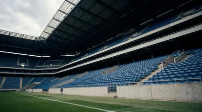 Empty Blue Stadium Seats Under Large Roof