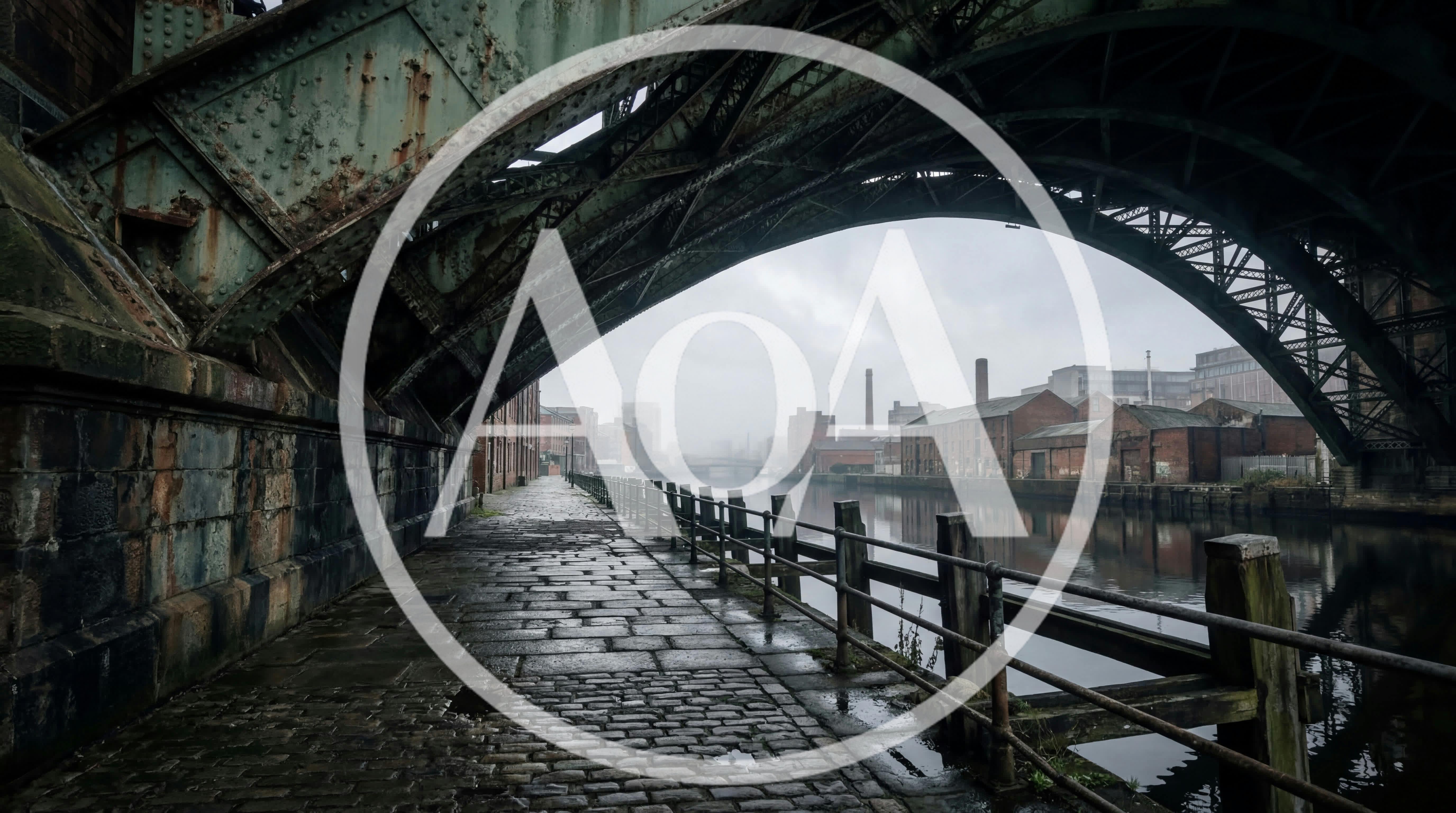 Cobblestone Path Under Industrial Bridge Along River
