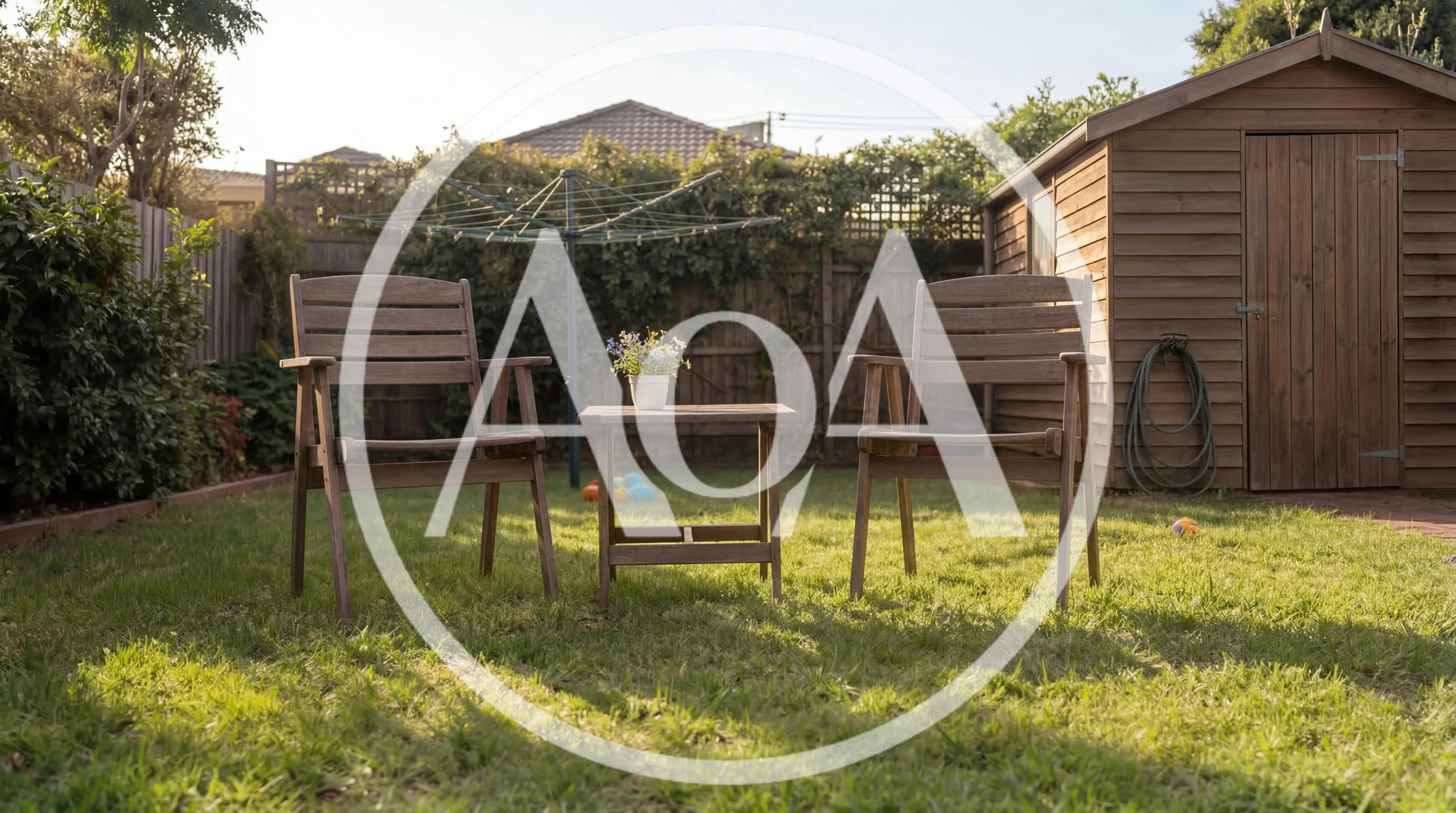 Two Wooden Garden Chairs And Table On Lawn