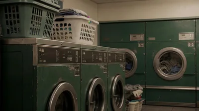 Vintage Green Industrial Washing Machines In A Laundromat