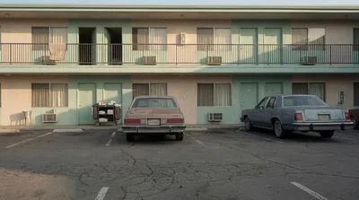Vintage Cars Parked Outside A Retro Motel