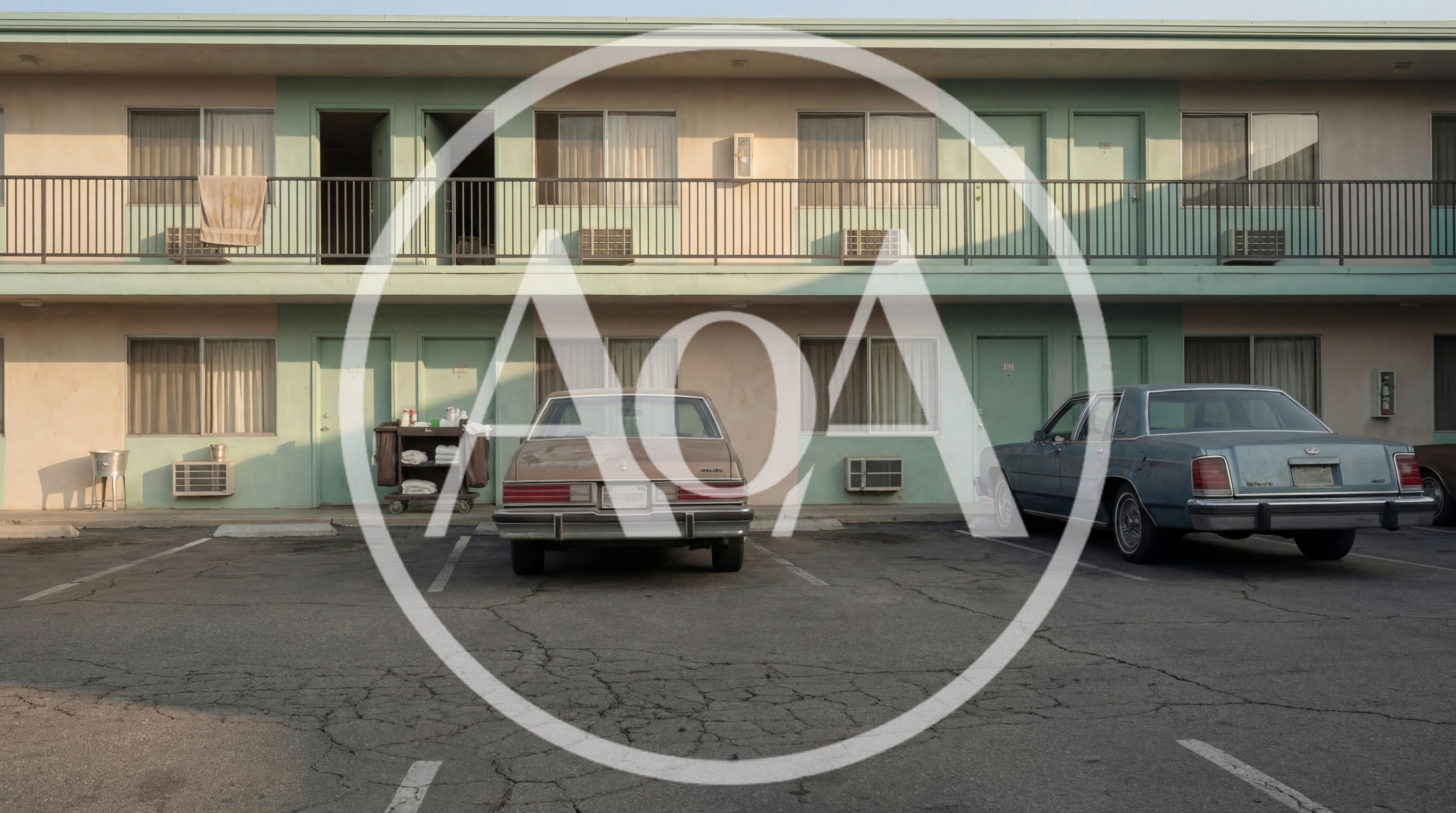 Vintage Cars Parked Outside A Retro Motel