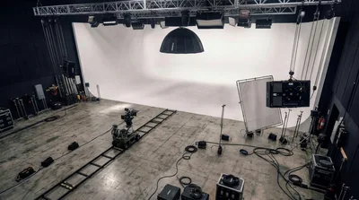Empty Film Studio With Camera Dolly And Lighting Equipment