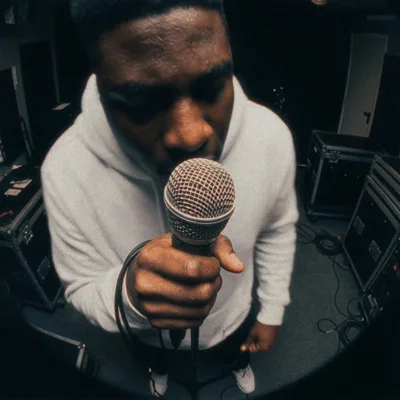Rapper Holding Microphone Performing In A Dark Studio