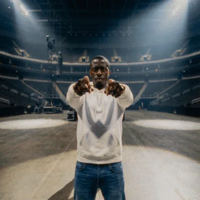 Man Pointing Fingers At Camera In Empty Arena