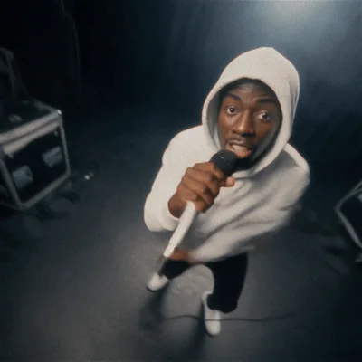 Young Man Rapping Into Microphone In Studio Setting