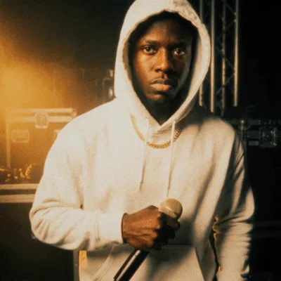 Rapper In White Hoodie Holding Microphone Performing On Stage
