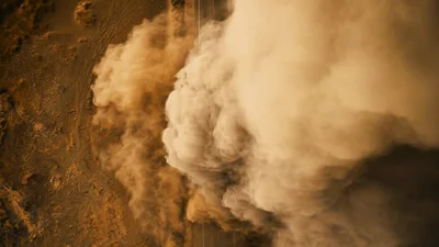 White Car Driving Through Massive Desert Dust Storm
