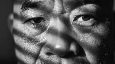 Close Up Portrait Of An Asian Man With Shadow Patterns